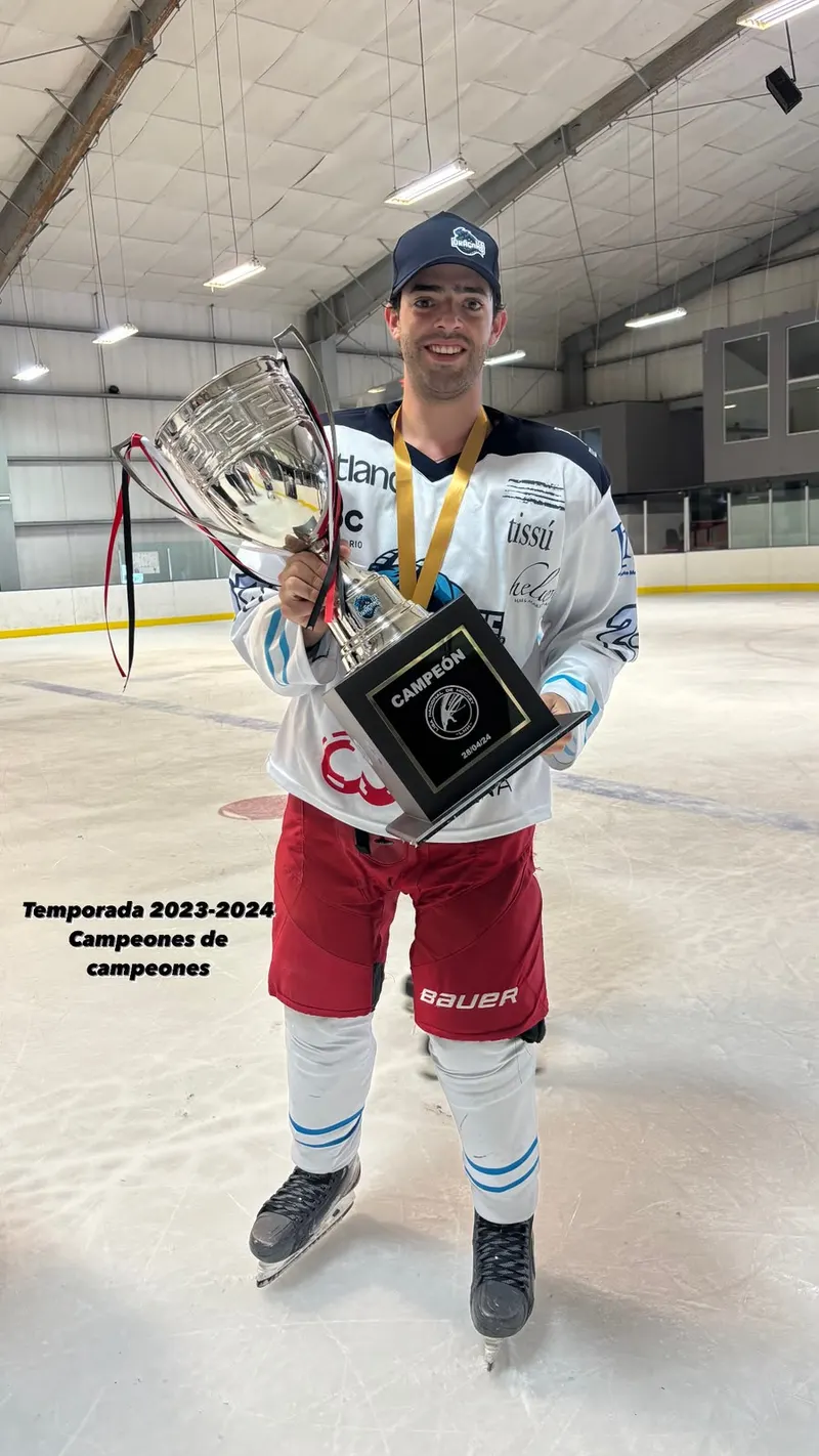 Diego on the ice holding the champion-of-champions cup and plaque, a captain’s C on his jersey.